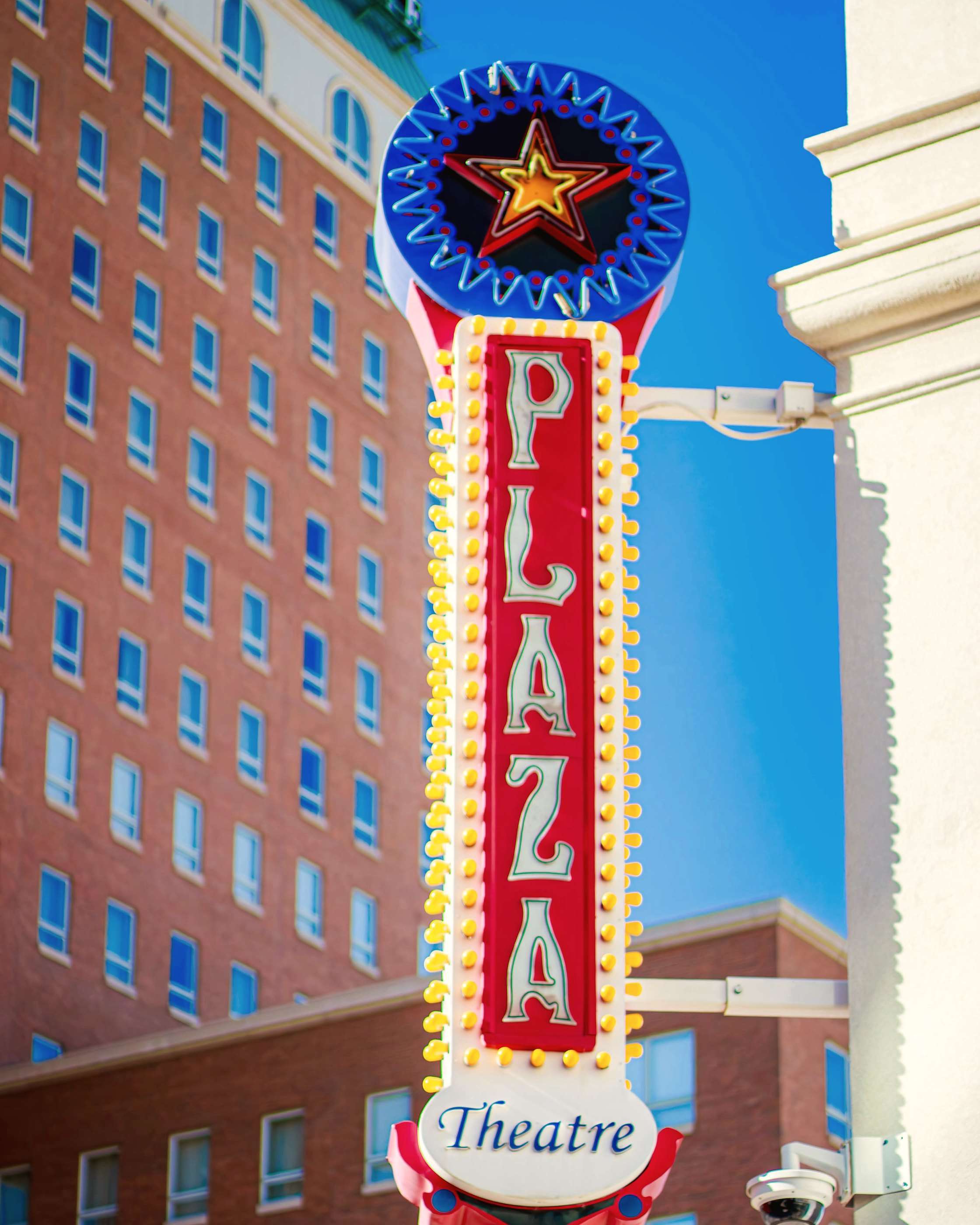The Plaza Theatre marquee sign in downtown El Paso against a blue sky
