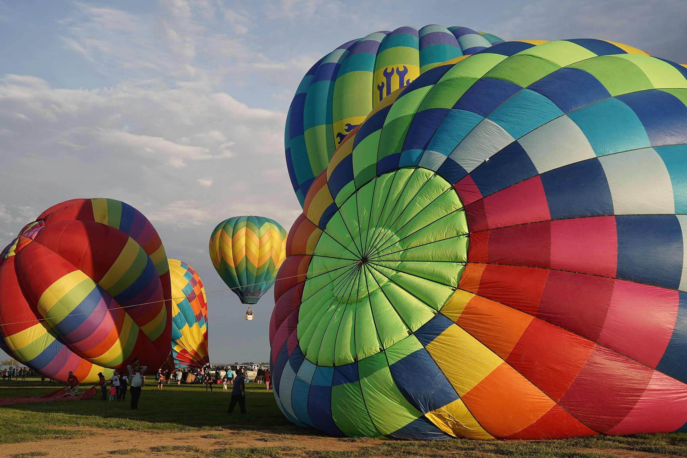 Hot air balloons inflating on a field near Alamogordo and White Sands National Park, New Mexico