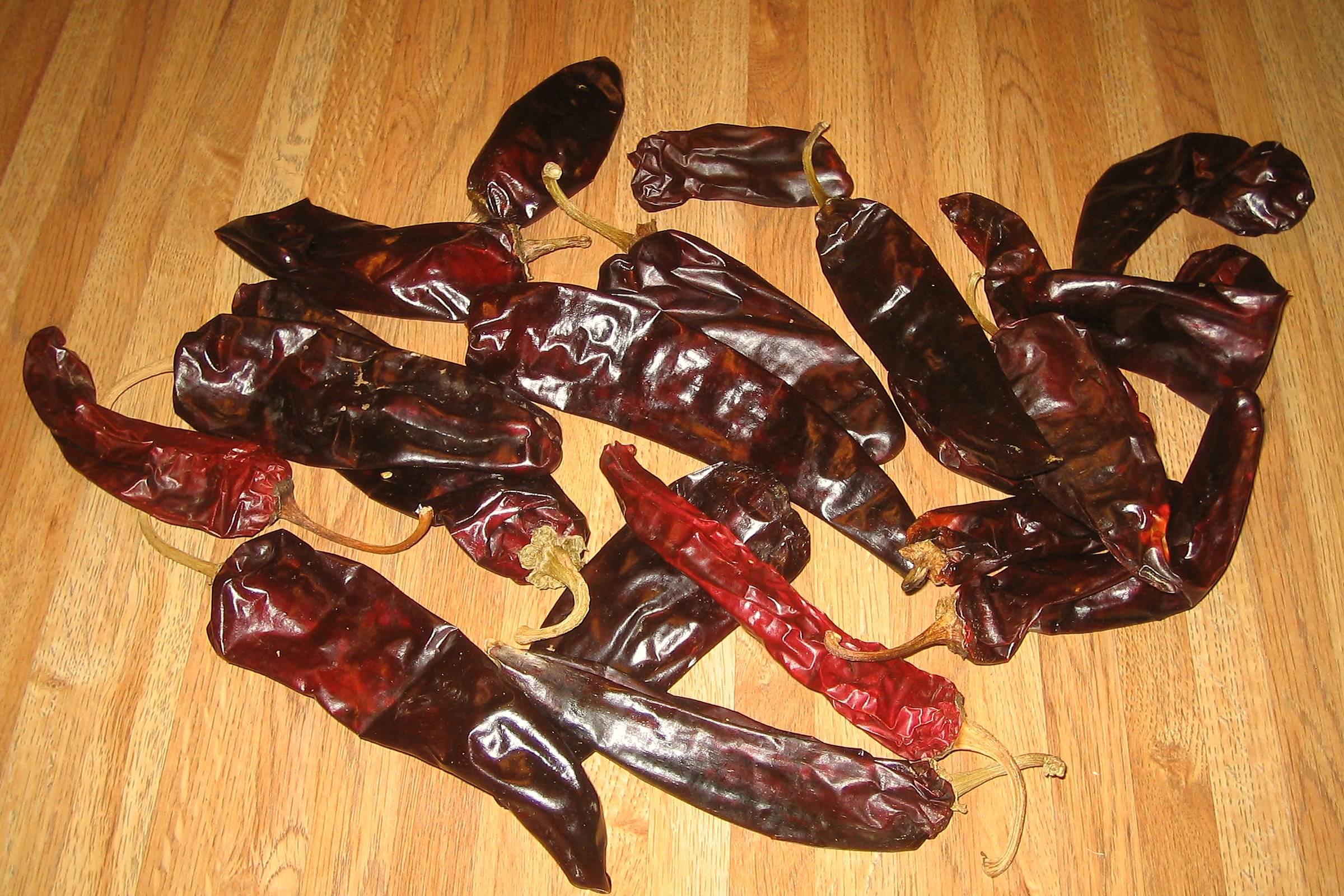 Dried red chiles from Hatch, New Mexico, spread on a wooden floor
