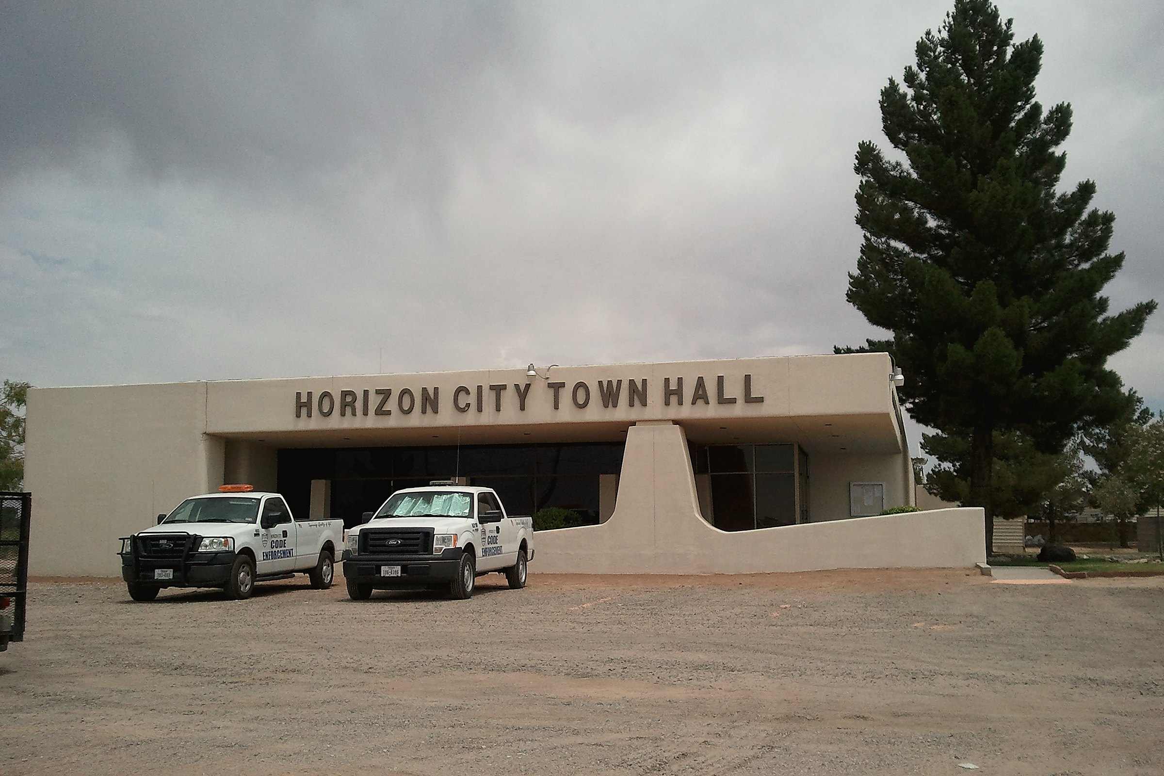 The Horizon City Town Hall in Horizon City, Texas, with a pine tree beside it