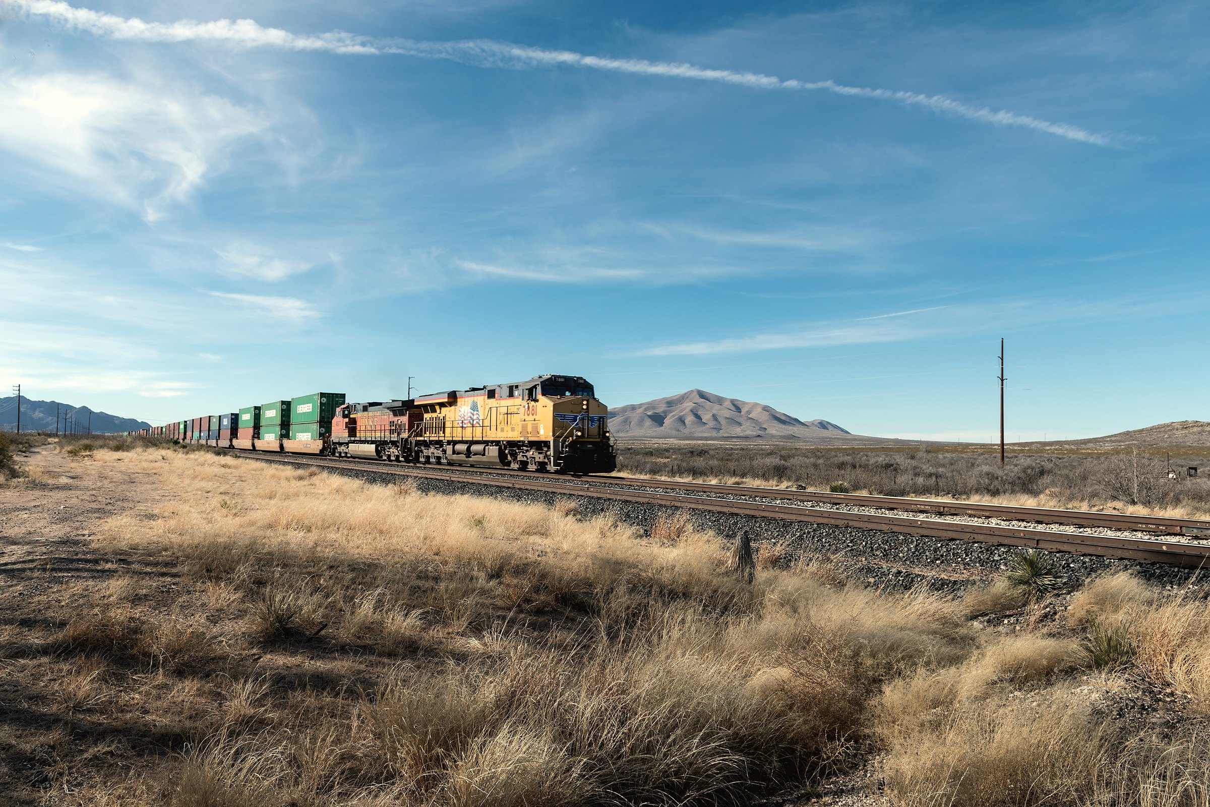 A freight train on the tracks near Sierra Blanca in Hudspeth County, Texas, mountains on the horizon