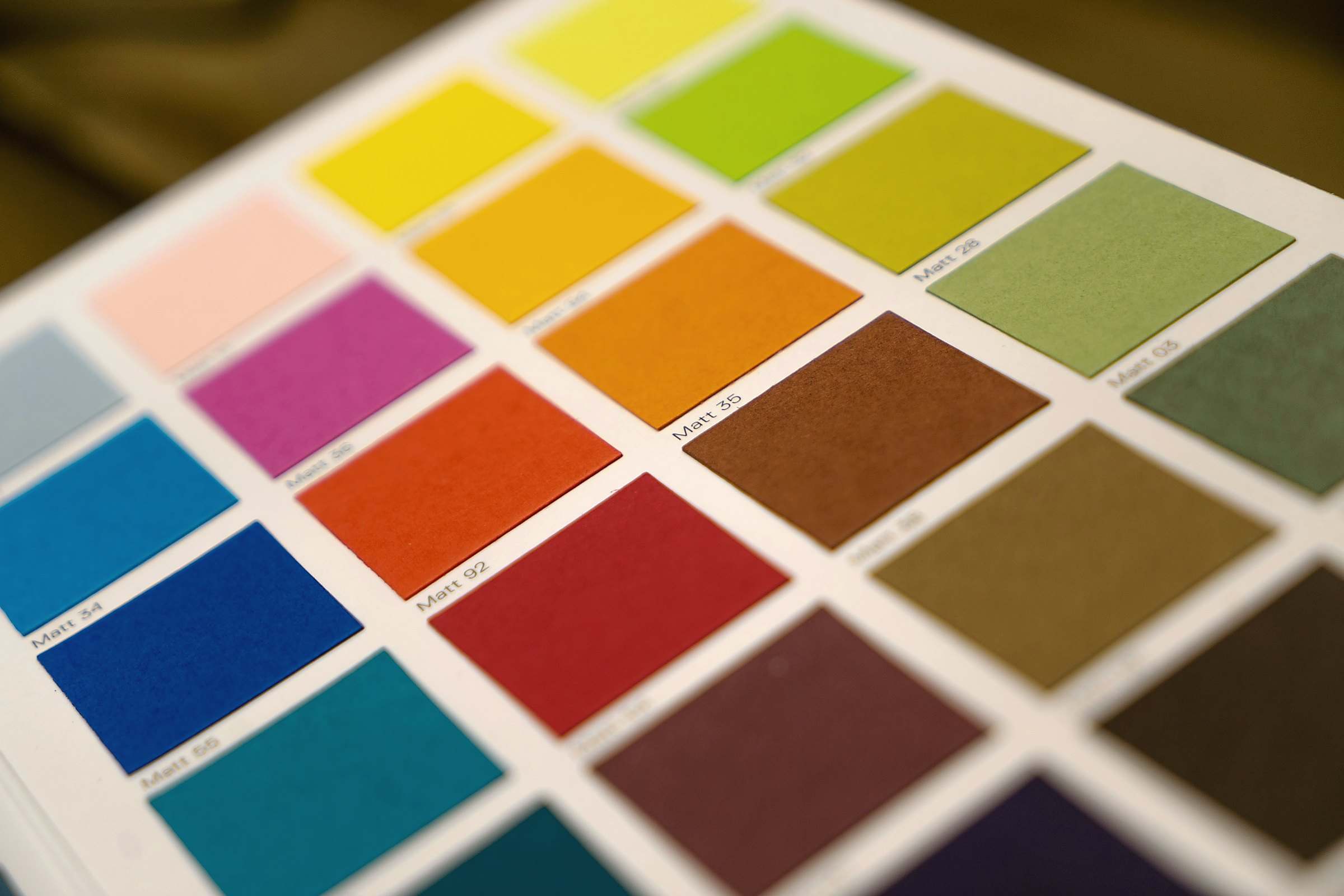 A grid of paper colour swatches in bright reds, yellows, greens and blues